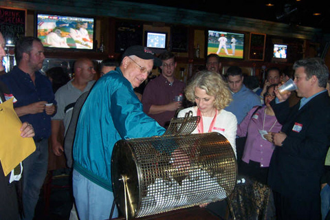 Art Horowitz ('53) draws raffle winners at Mudville 9.